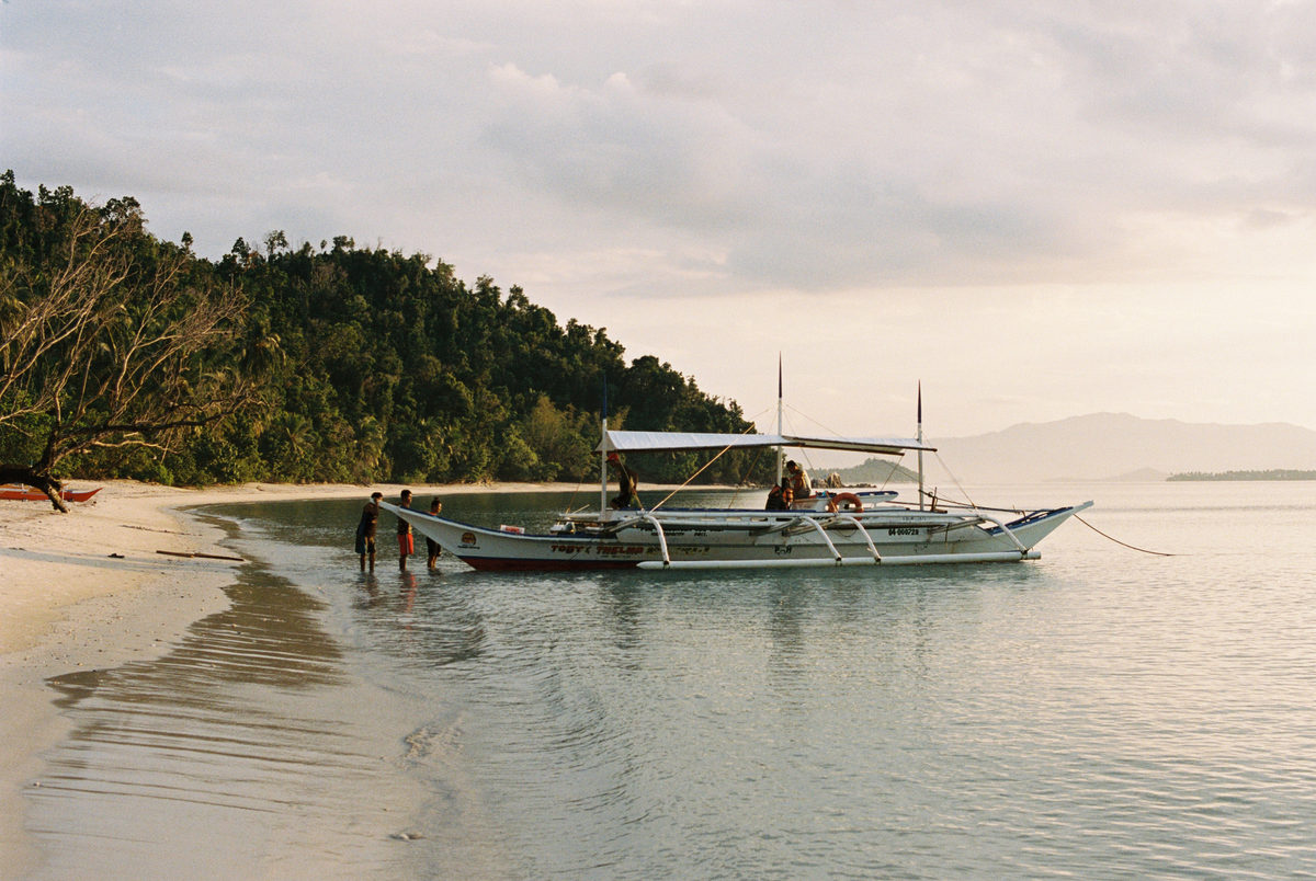 Outrigger boat resting in shallow water at low tide