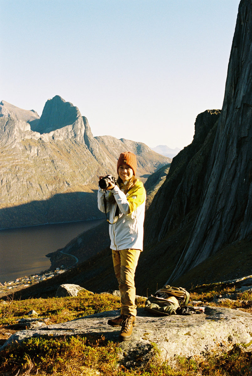 Margarette Contreras holding a camera in the mountains