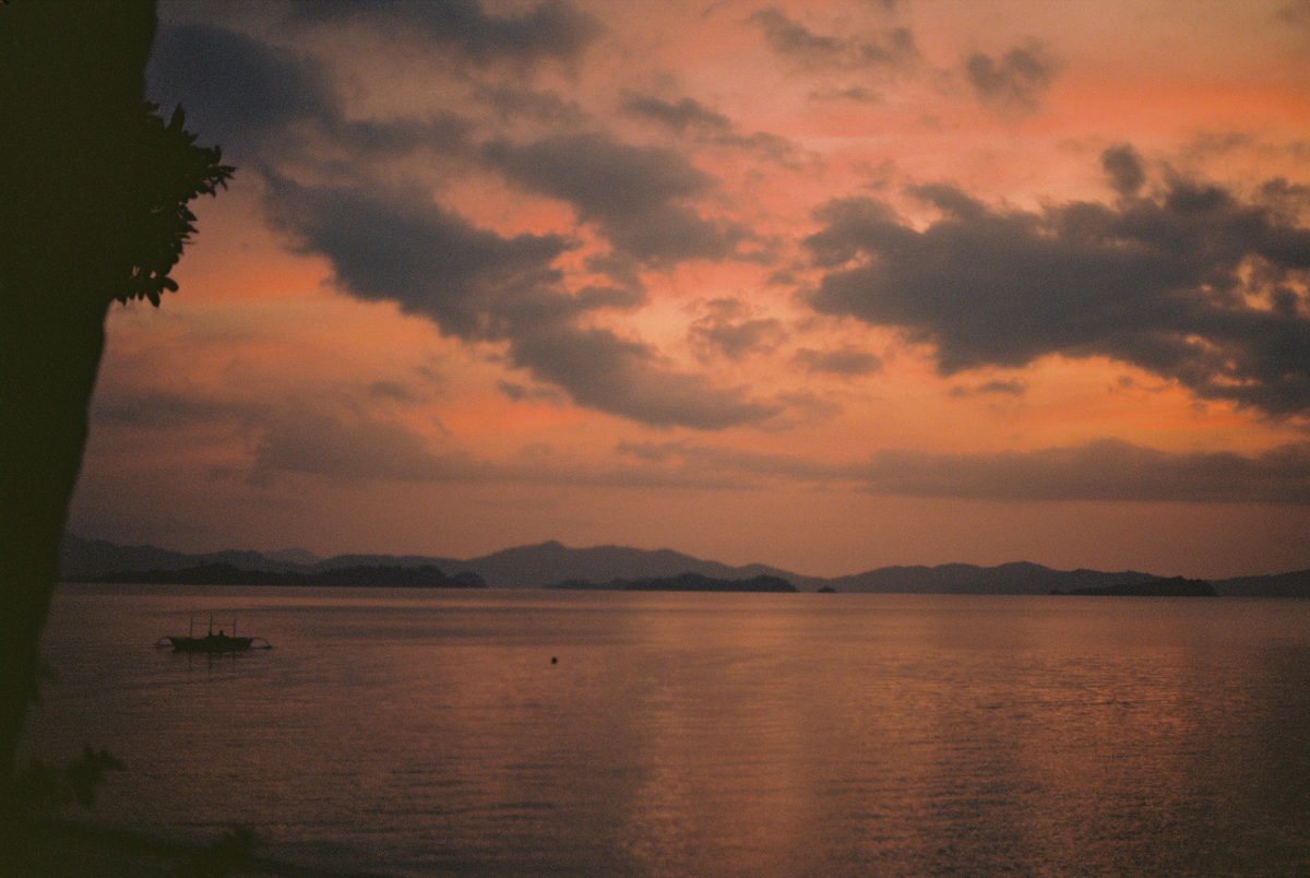 Pink and orange clouds over a dark sea at sunset